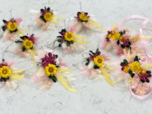 Modern minimalist buttonhole with simple floral design and greenery