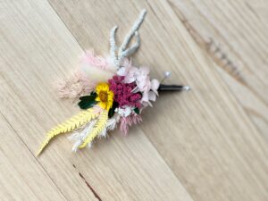 Red preserved flower buttonhole for groom with long-lasting floral design
