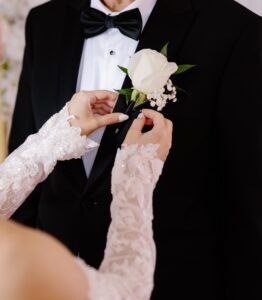 White rose wedding buttonhole with greenery designed by a professional florist