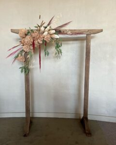 Wedding floral arch ceremony backdrop with preserved flowers and greenery designed by a professional florist