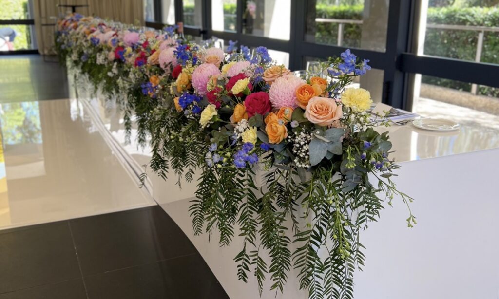 Bridal table adorned with fresh floral arrangements for a wedding reception