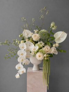 Artistic fresh flower arrangement in a vase with layered blooms and elegant styling.