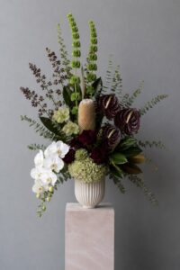 Modern fresh floral arrangement in a vase featuring premium blooms and layered textures.