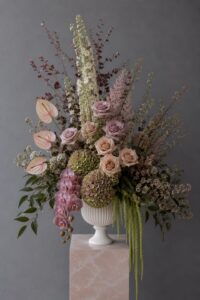Contemporary vase arrangement with fresh seasonal flowers and premium botanical elements.