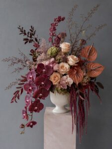 Fresh floral centrepiece in a vase featuring premium flowers and lush greenery.