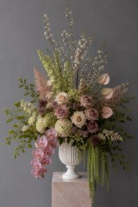 Luxury fresh flower arrangement in a vase showcasing layered flowers and natural textures.