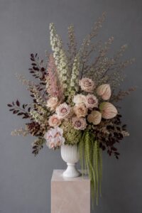 Contemporary fresh floral arrangement in a vase featuring premium seasonal flowers and foliage.
