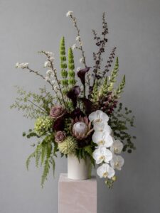 Premium fresh flower arrangement in a decorative vase featuring layered blooms.
