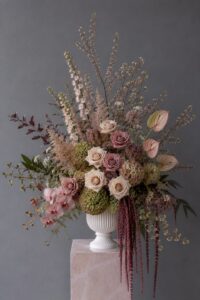Sculptural floral design in a vase with fresh flowers arranged in a contemporary style.