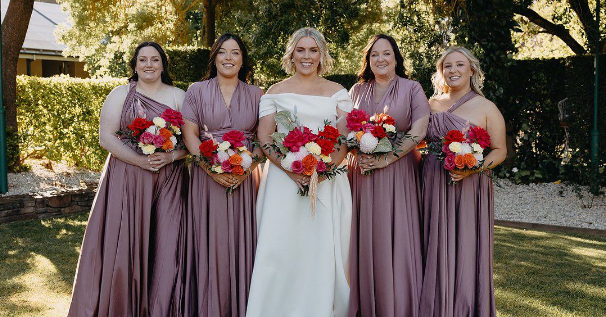 Bride and bridesmaids holding red bouquets flowers Melbourne wedding