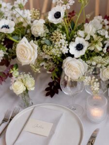 Elegant bridal table flowers with white and blush seasonal blooms arranged in a modern, low floral design for a luxury Melbourne wedding reception.